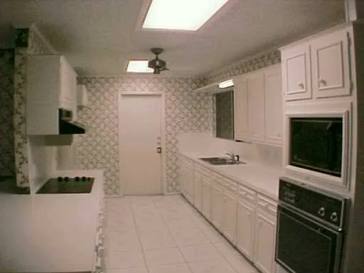 a kitchen with stainless steel appliances a stove refrigerator and cabinets