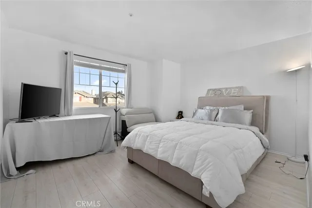 a large bedroom with two beds and a flat screen tv