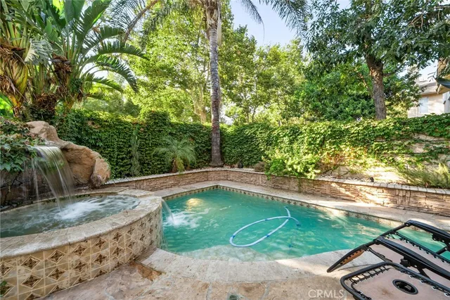 a view of a backyard with swimming pool