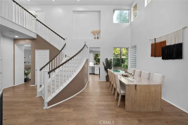 a dining room with wooden floor and furniture