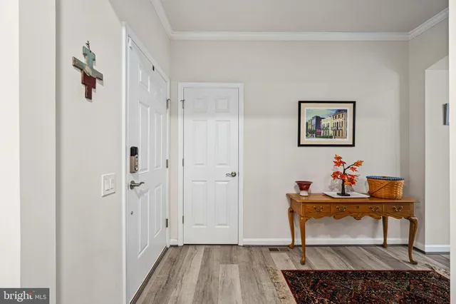 a kitchen with stainless steel appliances a dining table chairs and wooden floor