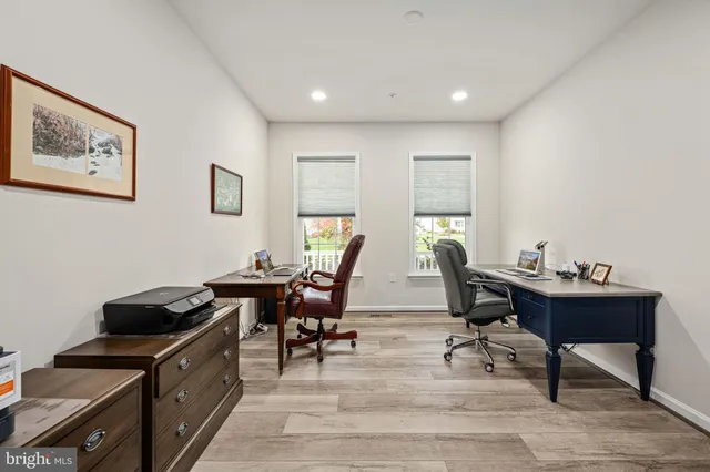a dining room with furniture and wooden floor
