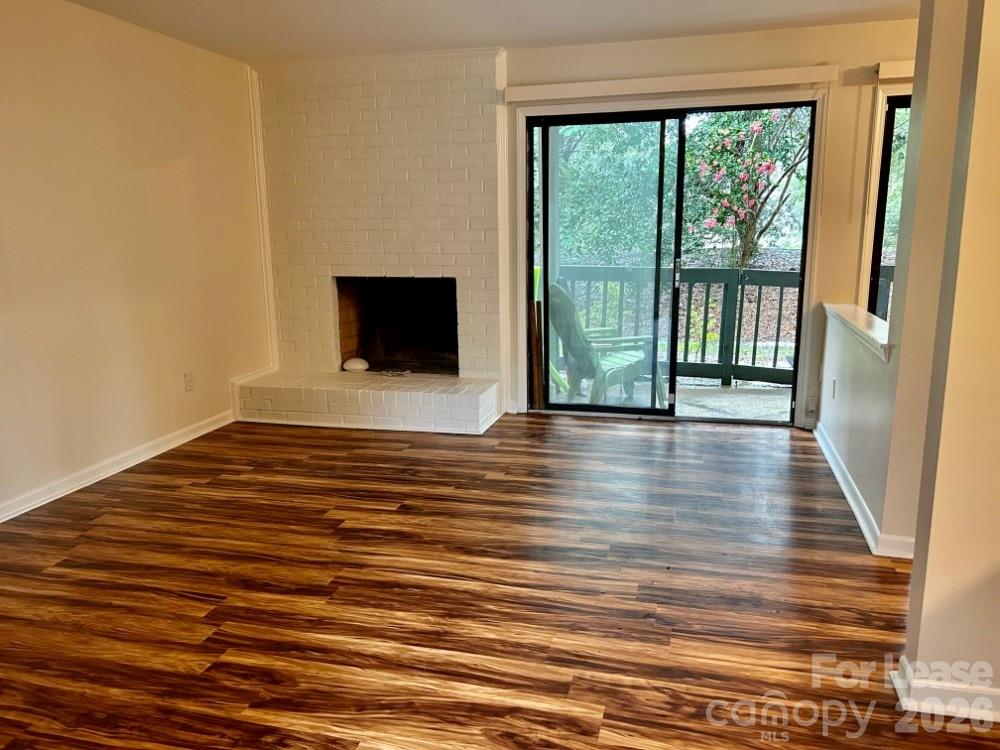 11020 Harrowfield Road Charlotte, NC 28226 - Photo 5 of 14 a view of an empty room with wooden floor and a window