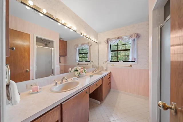 a bathroom with a sink double vanity granite and a mirror