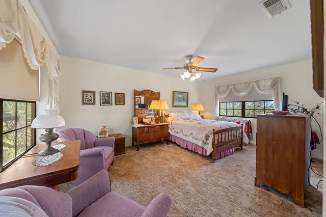 a bedroom with a bed couch and window