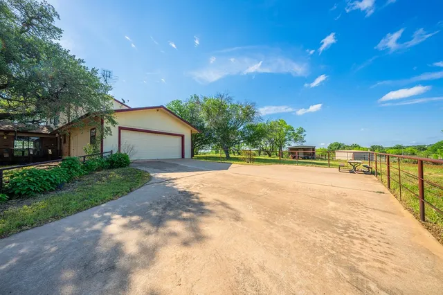 a view of house with yard and swimming pool