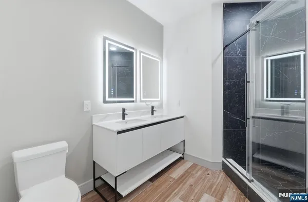 a bathroom with a sink toilet and mirror