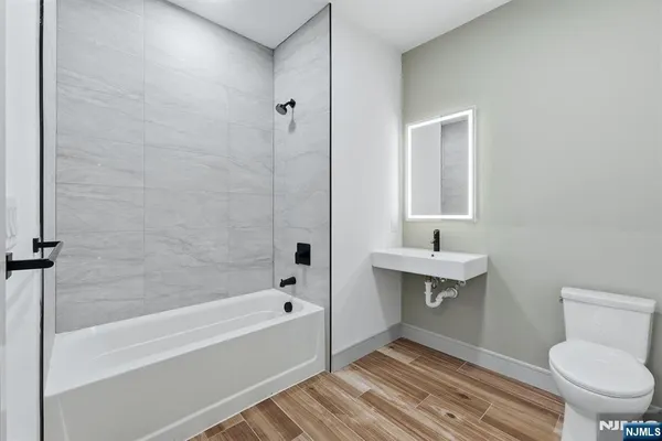 a bathroom with a toilet and a bathtub
