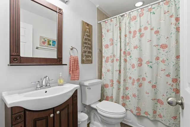 a bathroom with a sink a toilet and bathtub