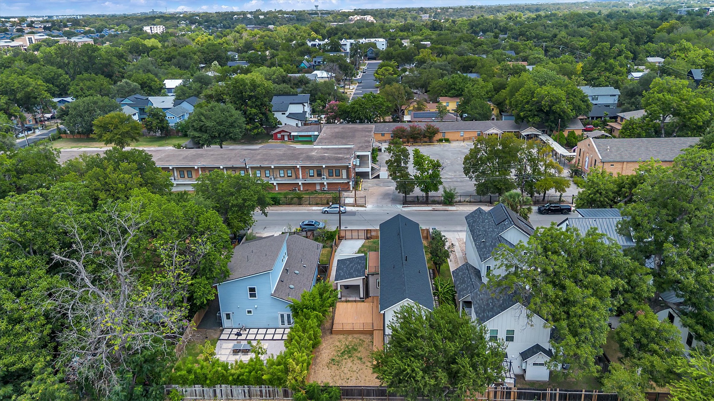 3101 Lyons Road Austin, TX 78702 - Photo 34 of 40 An aerial perspective reveals a vibrant neighborhood with diverse rooftops amidst a lush tree canopy.