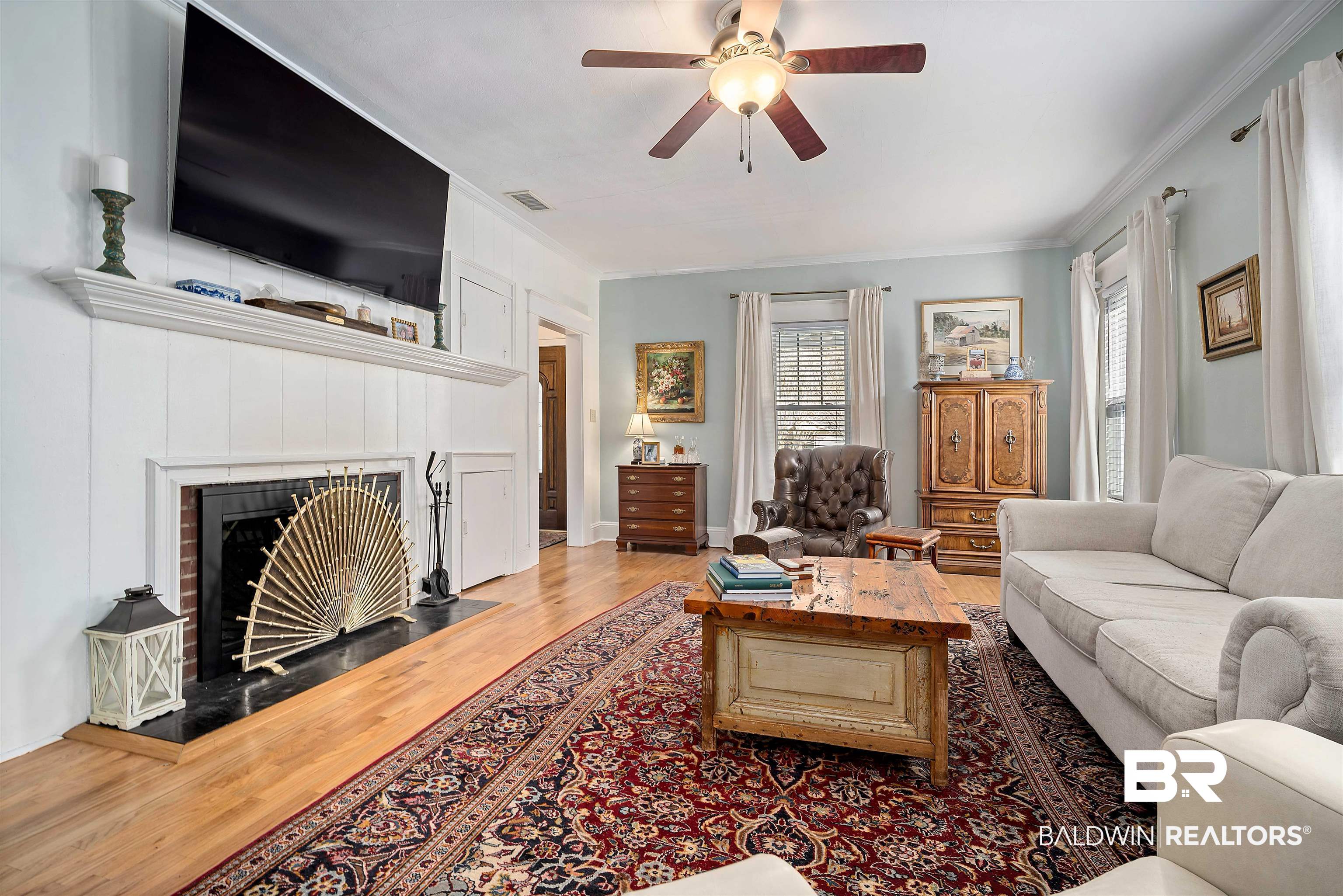 168 Mohawk Street Mobile, AL 36606 - Photo 9 of 31 Living area featuring ceiling fan, light wood-type flooring, ornamental molding, and a fireplace