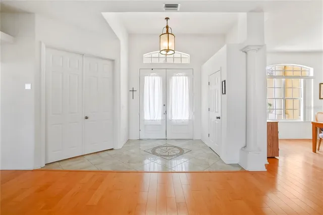 a view of a livingroom with wooden floor and a window