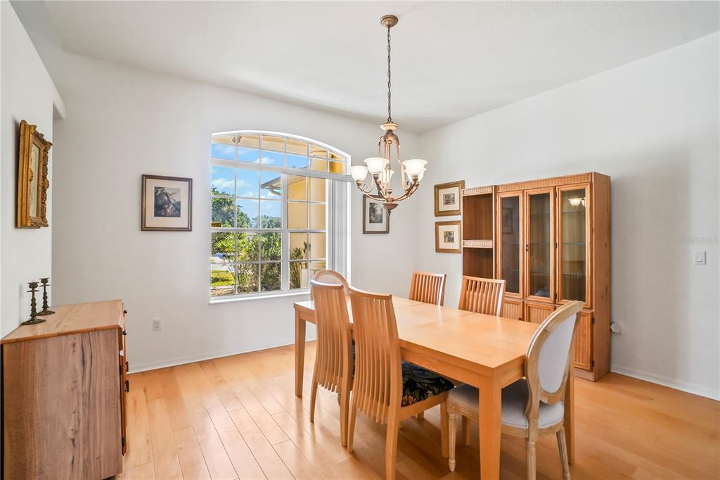3441 Cedar Crest Loop Spring Hill, FL 34609 - Photo 14 of 58 a view of a dining room with furniture window and wooden floor