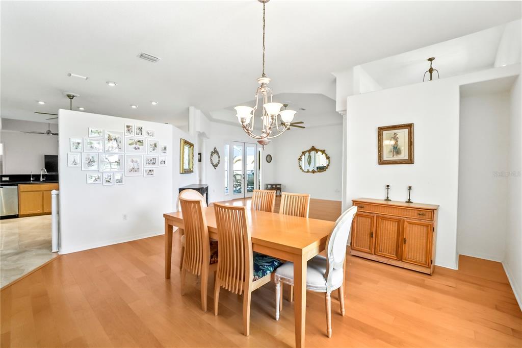 3441 Cedar Crest Loop Spring Hill, FL 34609 - Photo 15 of 58 a dining room with wooden floor and chandelier