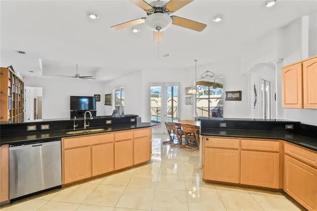 a kitchen with granite countertop a sink stove top oven and cabinets