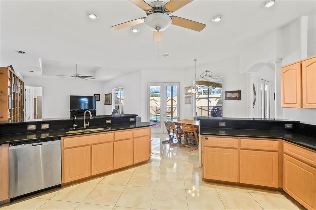 3441 Cedar Crest Loop Spring Hill, FL 34609 - Photo 16 of 58 a kitchen with granite countertop a sink a counter top space appliances and cabinets
