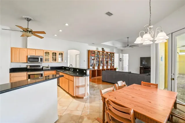 a kitchen with stainless steel appliances granite countertop a sink a stove and a refrigerator