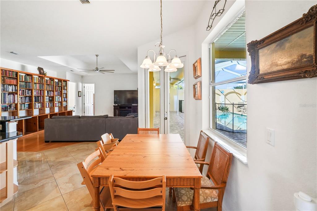 3441 Cedar Crest Loop Spring Hill, FL 34609 - Photo 26 of 58 a view of a dining room with furniture and a chandelier