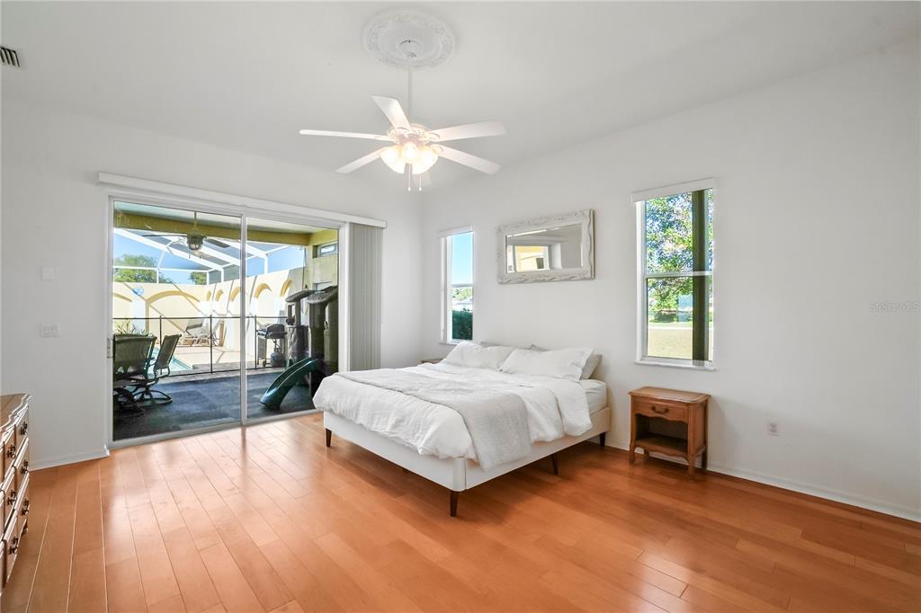 3441 Cedar Crest Loop Spring Hill, FL 34609 - Photo 28 of 58 a spacious bedroom with a large bed and a window