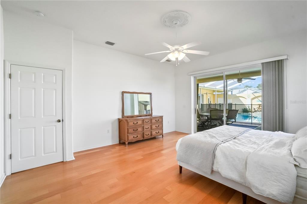 3441 Cedar Crest Loop Spring Hill, FL 34609 - Photo 29 of 58 a bedroom with a large bed and a chandelier