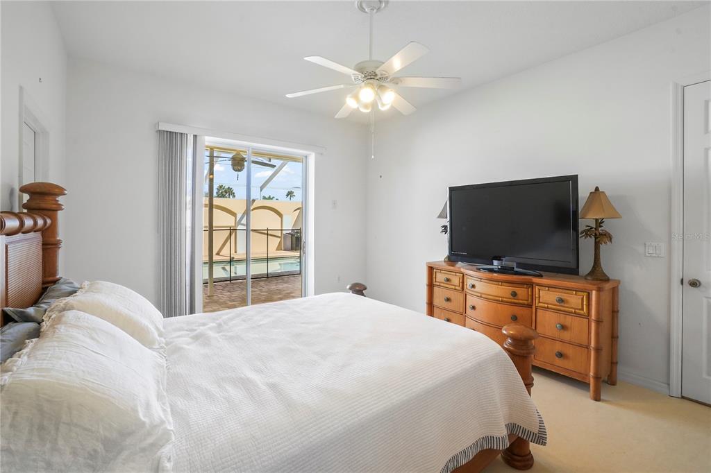 3441 Cedar Crest Loop Spring Hill, FL 34609 - Photo 47 of 58 a bedroom with a bed and a flat screen tv