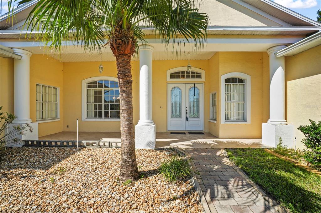 3441 Cedar Crest Loop Spring Hill, FL 34609 - Photo 5 of 58 a front view of a house with garden