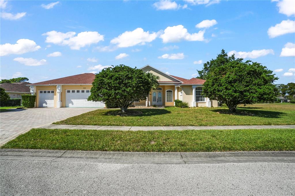 3441 Cedar Crest Loop Spring Hill, FL 34609 - Photo 54 of 58 a front view of a house with a yard