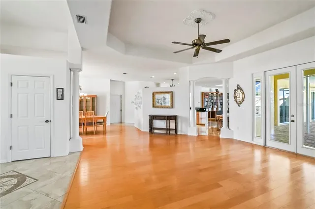 a view of a livingroom with hardwood floor and a ceiling fan