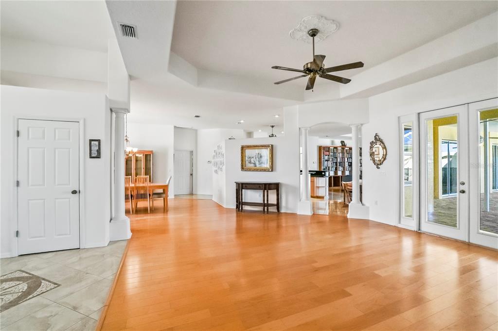 3441 Cedar Crest Loop Spring Hill, FL 34609 - Photo 7 of 58 a view of a livingroom with hardwood floor and a ceiling fan