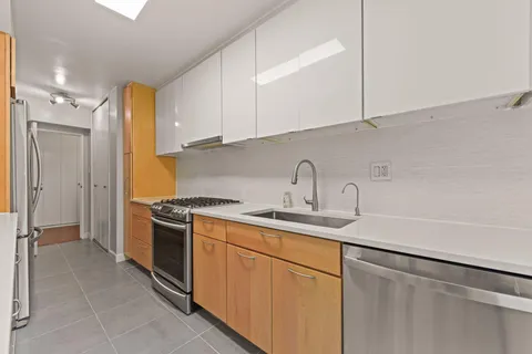 a kitchen with a sink stove and refrigerator
