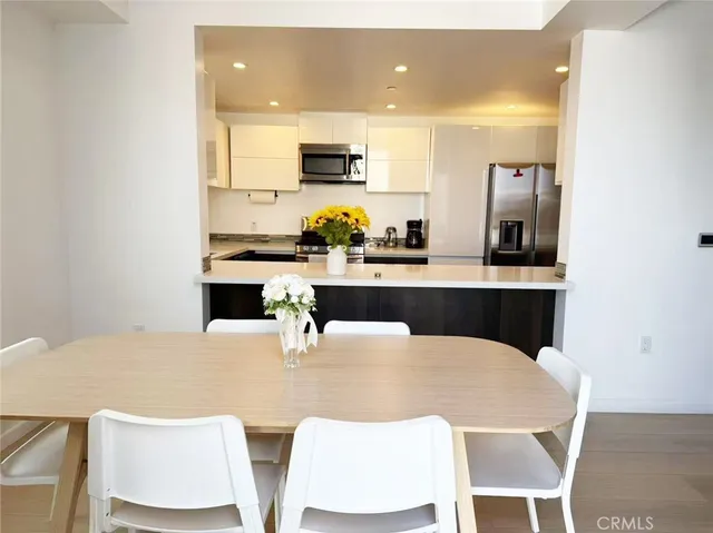 a kitchen with a table chairs sink and microwave