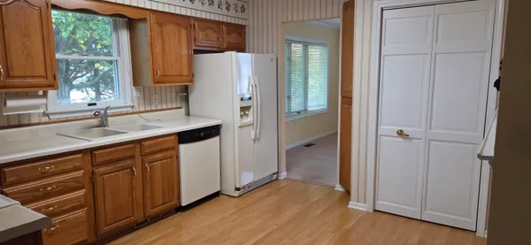 a kitchen with a refrigerator and a sink