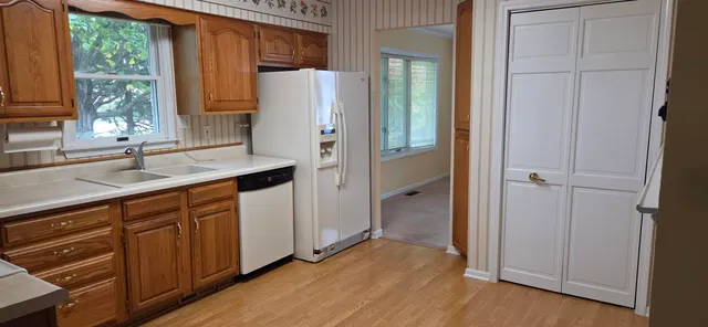 a kitchen with a refrigerator and a sink