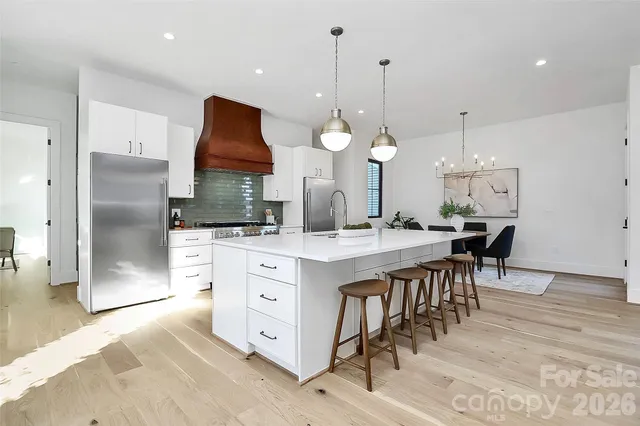 a large room with kitchen island a chandelier and living room view