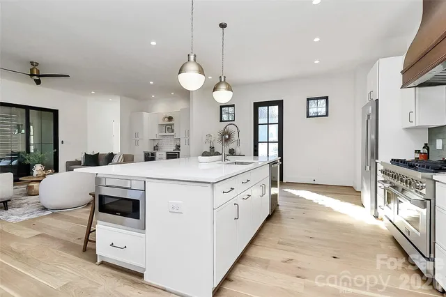 a kitchen with white cabinets and white appliances