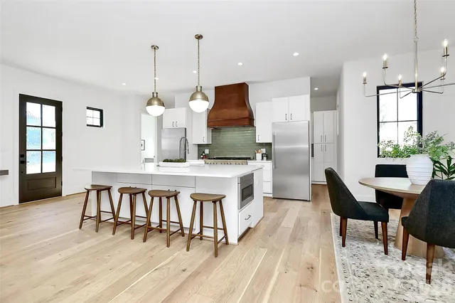 a bed room with a bed mirror and a table