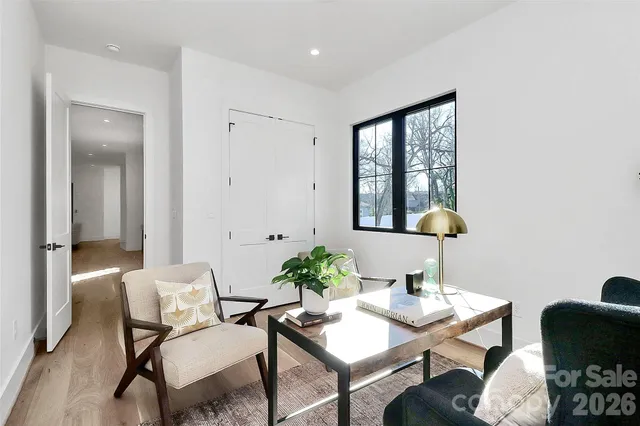 a bathroom with a large tub a sink and a window