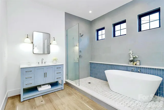 a view of a room with wooden floor and white walls