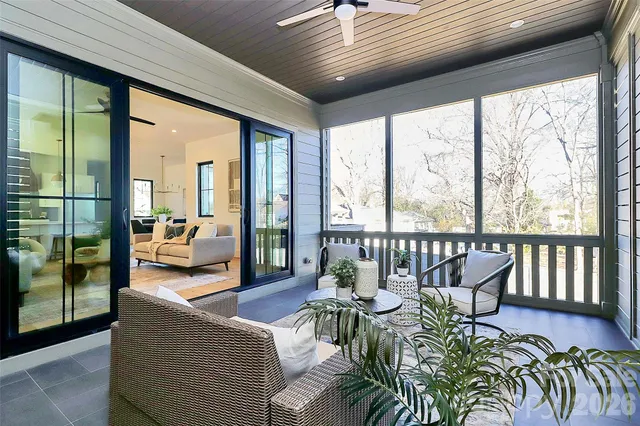 a living room with furniture and large windows