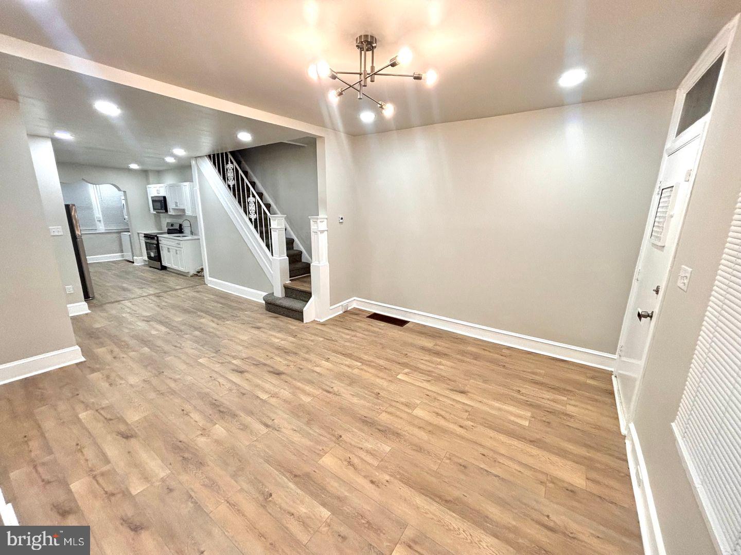 3023 Redner Street Philadelphia, PA 19121 - Photo 14 of 22 wooden floor in an empty room with a chandelier