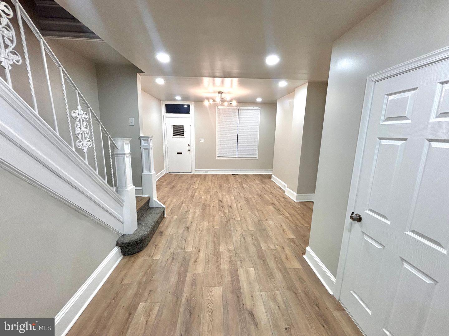 3023 Redner Street Philadelphia, PA 19121 - Photo 15 of 22 a view of a hallway with wooden floor and staircase