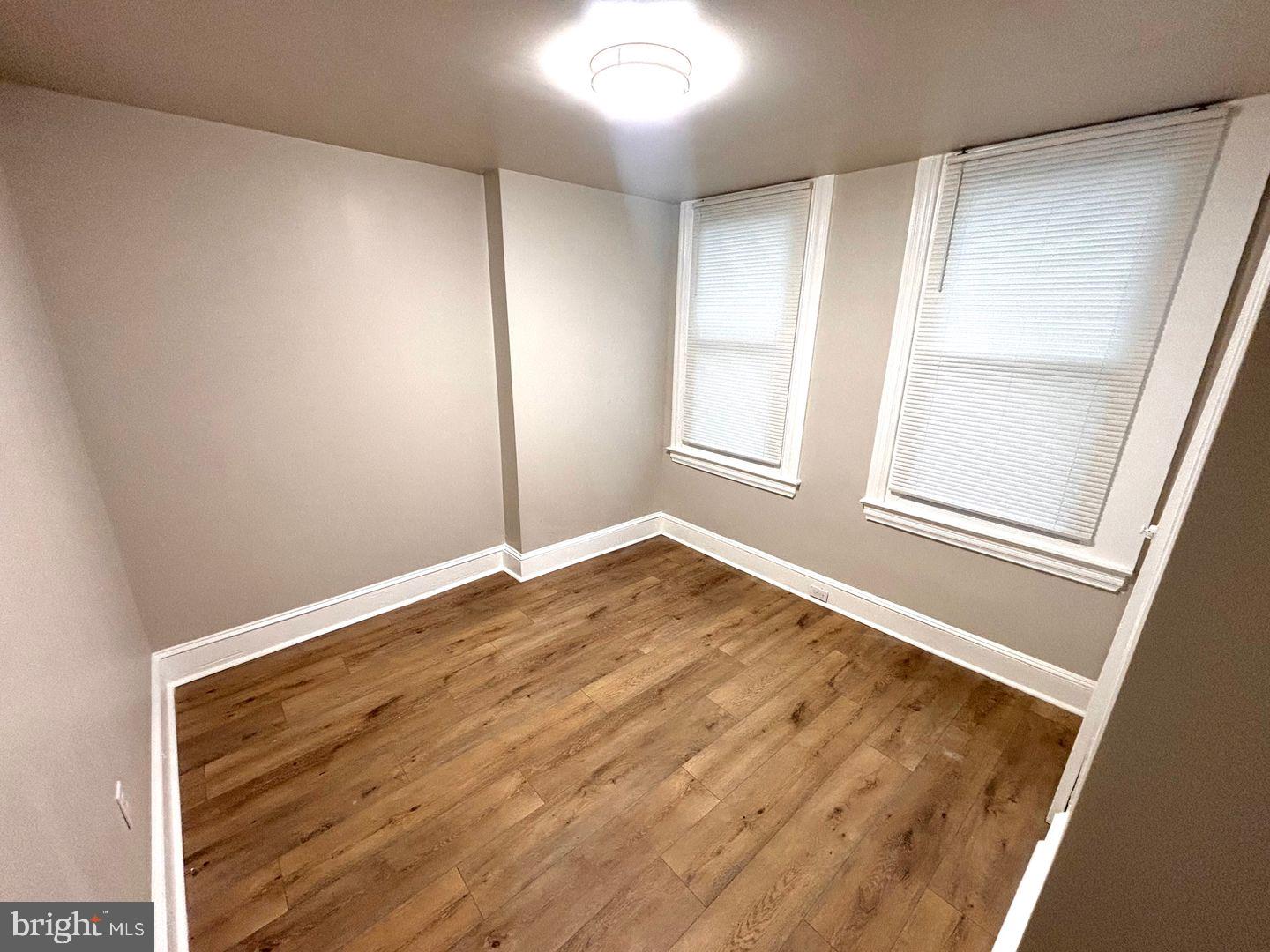 3023 Redner Street Philadelphia, PA 19121 - Photo 3 of 22 an empty room with wooden floor and windows