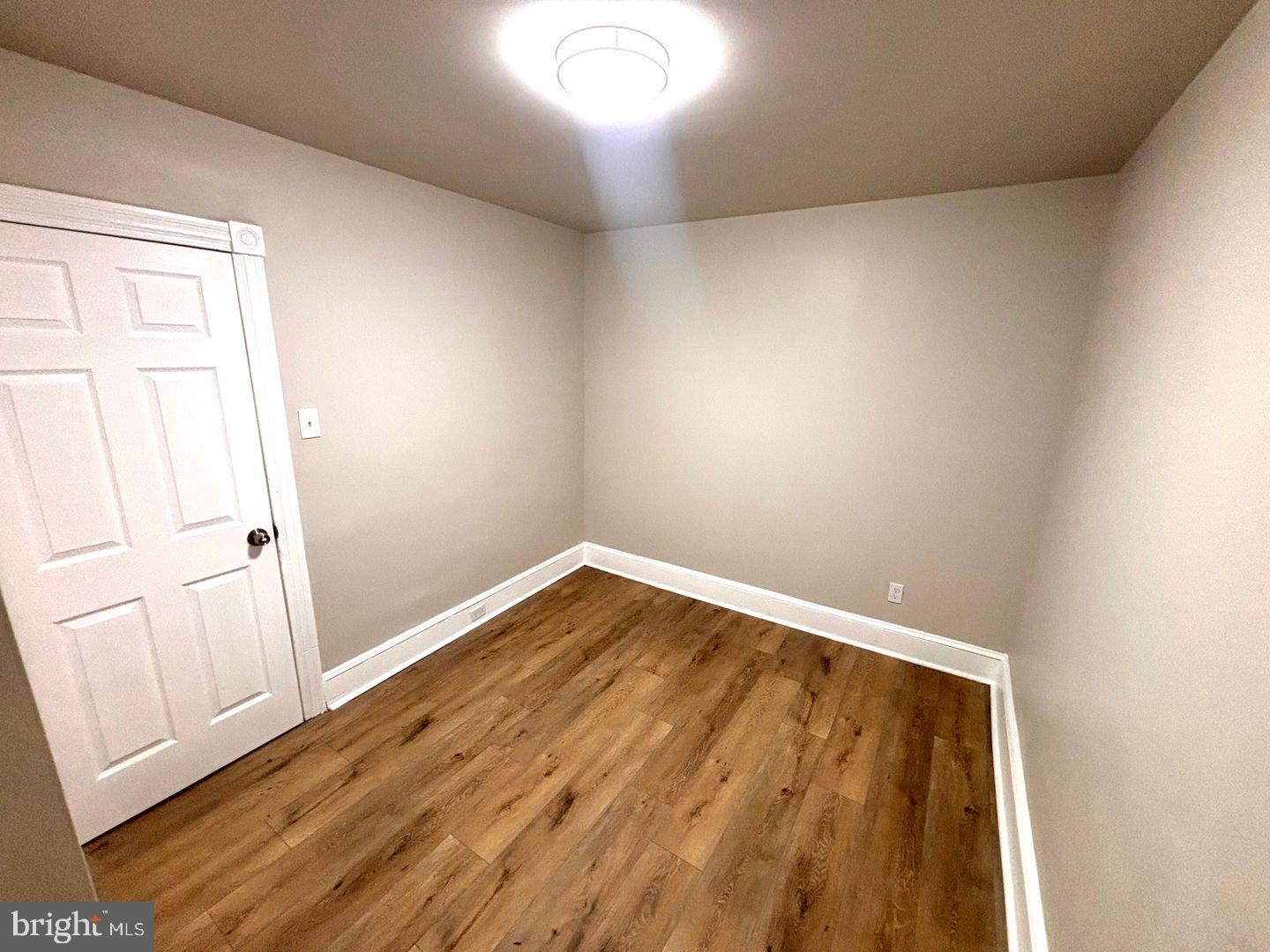 3023 Redner Street Philadelphia, PA 19121 - Photo 8 of 22 an empty room with wooden floor and windows