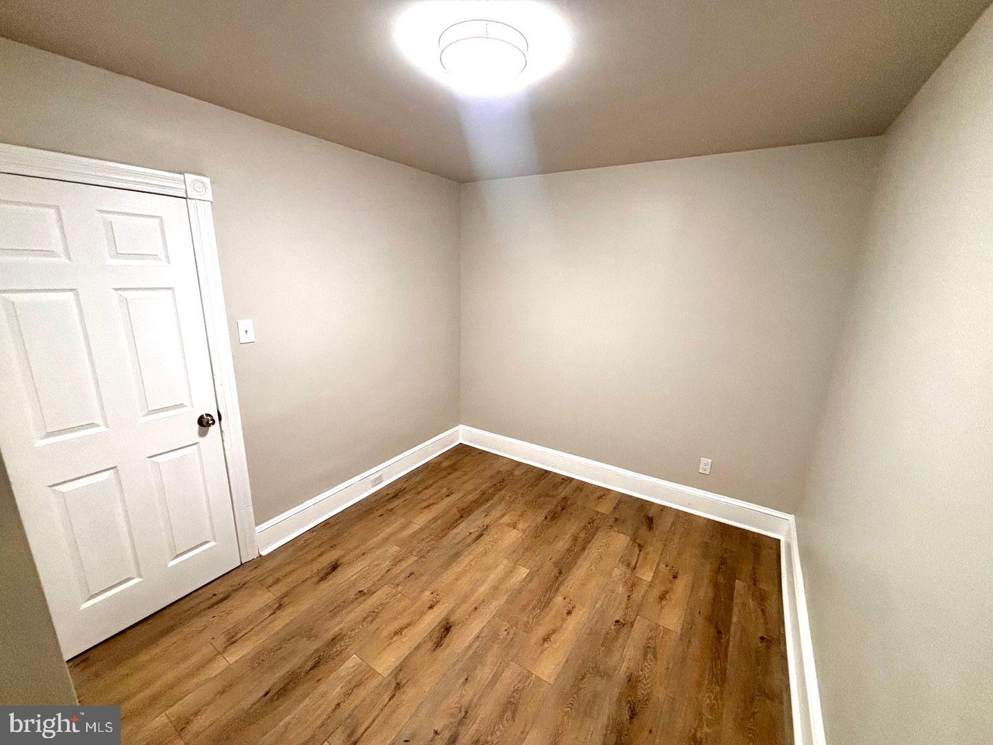 3023 Redner Street Philadelphia, PA 19121 - Photo 9 of 22 an empty room with wooden floor and windows