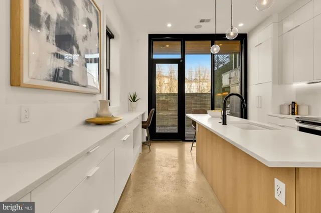 a large kitchen with a large window and stainless steel appliances