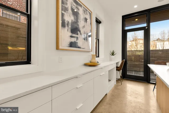 a kitchen with stainless steel appliances a sink and a large window
