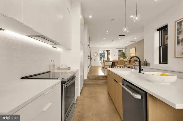 a kitchen with a sink a stove and cabinets