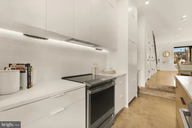 a kitchen that has a sink and a stove