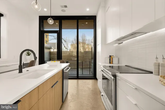 a kitchen with a sink and a stove top oven