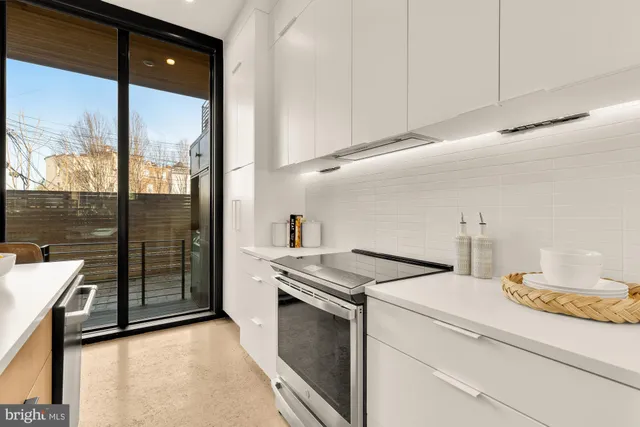 a kitchen that has a sink and a stove